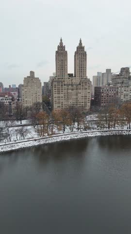 Snowy Central Park landscape with iconic skyscrapers in Manhattan, New York, USA
