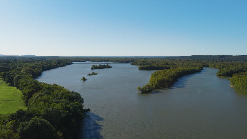 Broad river bend surrounded by trees and wetlands in rural Arkansas, aerial panoramic pullback, Cane Creek Recreation Area