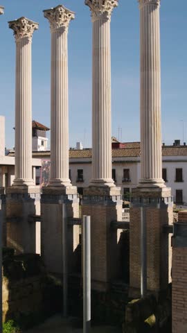 Córdoba’s ancient Roman temple, showing marble pillars and historic remains. Vertical aerial.