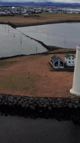 Drone footage showing the Grotta lighthouse with the Reykjavik cityscape in the background