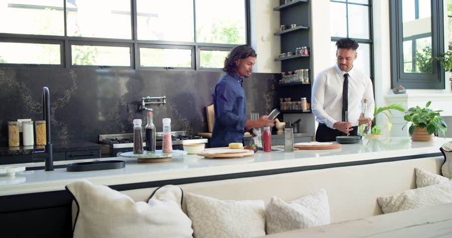 Diverse friends meeting at kitchen island, men starting setup, opening bottle and pouring drinks. Gathering, guests, social, camaraderie, countertop, modern, bright