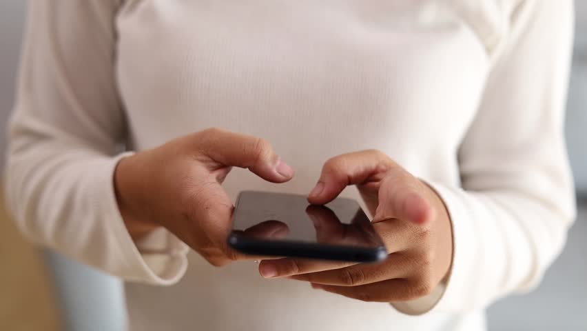 A Woman's Hands Holding a Phone. chatting, tapping, scrolling. Close up