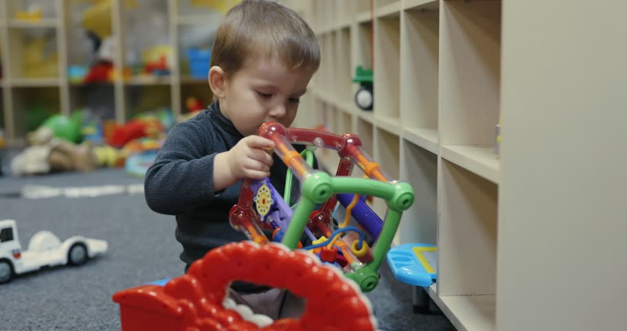 A boy plays with toys at the kids club
