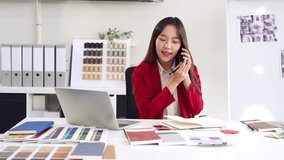 Happy interior designer speaking over the phone in her home office. Creative business woman taking notes during a phone call with her clients. Female designer working on a new project remotely. - Powered by Shutterstock - Get 15% off with code: PIKWIZARD15