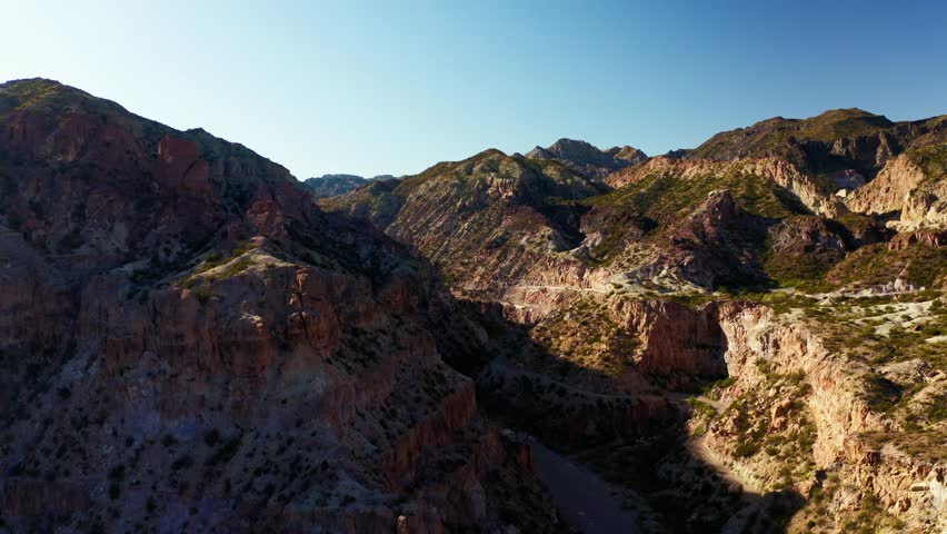 Aerial orbit along rugged canyon walls and eroded rock faces, Canon Del Atuel, Mendoza Argentina