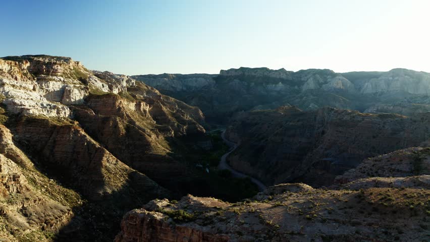 Aerial pullback of deep canyon cutting through vast Mendoza desert, Canon Del Atuel Argentina