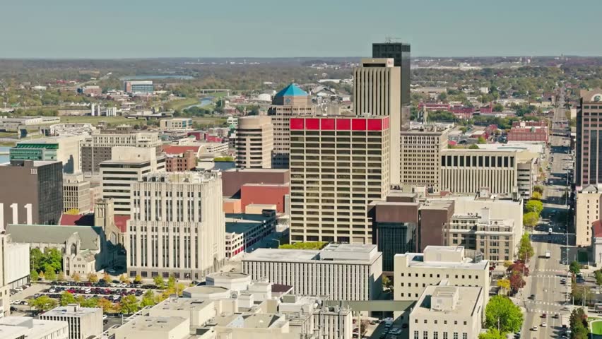 Aerial view of downtown Dayton, Ohio, with modern buildings, clear blue sky, and vibrant urban cityscape showcasing architectural details.