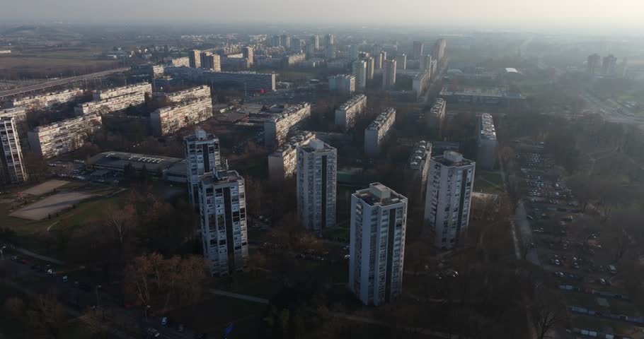 Panoramic view of iconic Brutalist residential towers in Croatia's capital during golden hour.