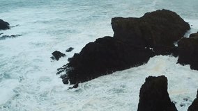 Drone shot of waves hitting a sea stack in the Atlantic near the Isle of Lewis. - Powered by Shutterstock - Get 15% off with code: PIKWIZARD15