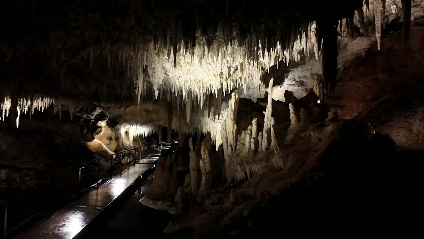 Illuminated Underground Lake Cave With Stalactites, Stalagmites and Reflective Cave Pool in Limestone Cavern, Western Australia