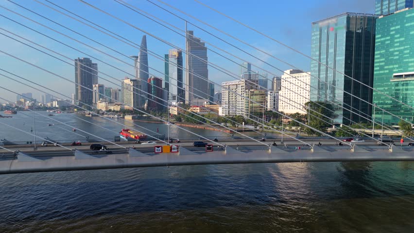 Modern skyline of Ho Chi Minh City with skyscrapers along Saigon River and cable-stayed bridge. Urban business district, traffic and waterfront architecture in Vietnam.