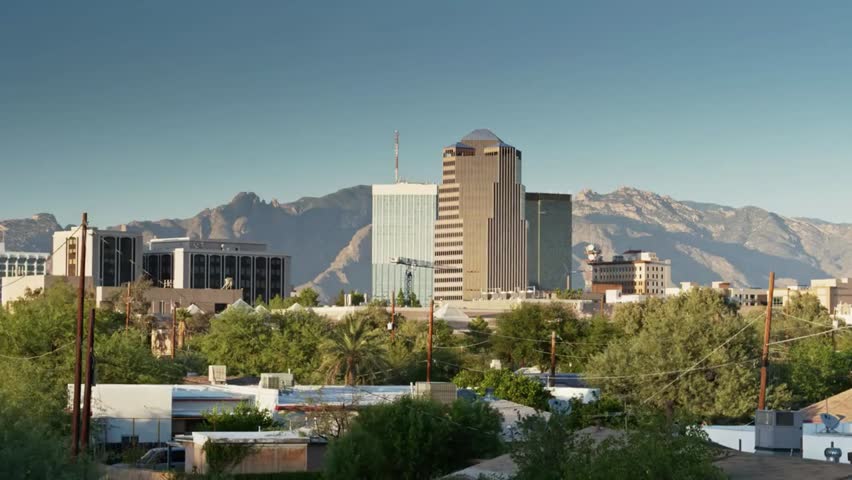 Tucson, Arizona skyline with mountains in the background on a clear sunny day, showcasing urban landscape and scenic desert surroundings.