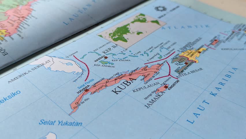 Hand pointing at a map of Cuba. Illustration of studying geography, analyzing places and routes. Cuba is a country located in the Caribbean, North America.
