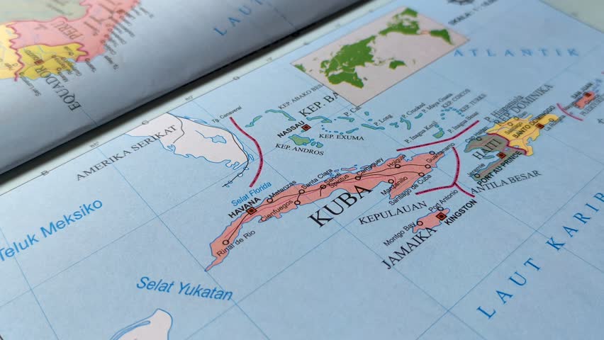 Hand pointing at a map of Cuba. Illustration of studying geography, analyzing places and routes. Cuba is a country located in the Caribbean, North America.