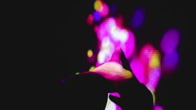 Hand glides across immersive projection wall as vibrant colors ripple like liquid light in a dark space. - Powered by Shutterstock - Get 15% off with code: PIKWIZARD15