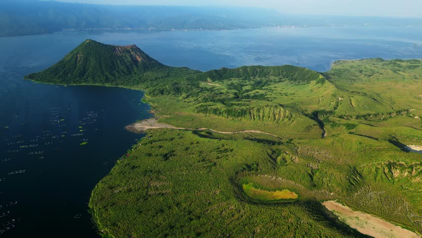 Classic establishing aerial shot of Taal Volcano and surrounding lake, ideal for documentaries, films, and travel visuals.
