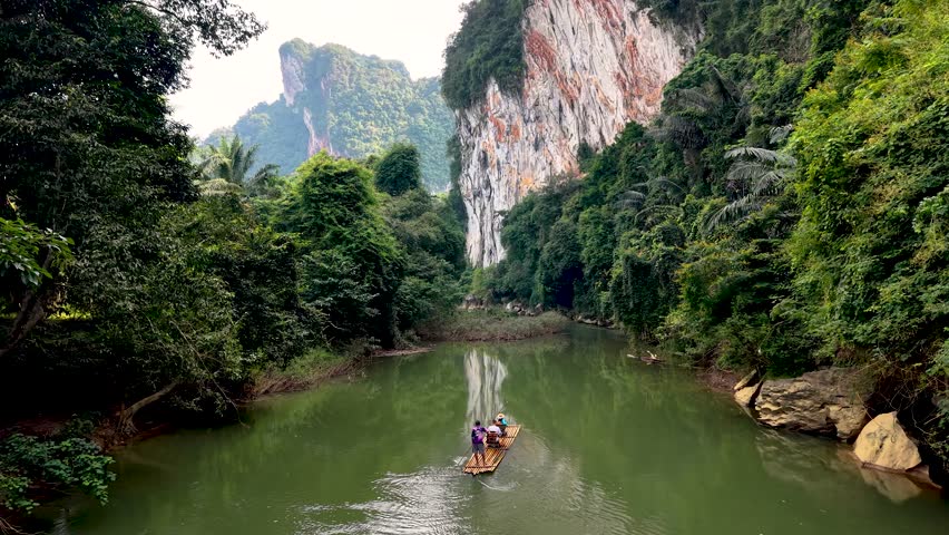 Experience the calm waters of Khao Sok as a bamboo raft glides through lush greenery and stunning cliffs. This breathtaking getaway showcases Thailand natural charm and tranquil atmosphere.