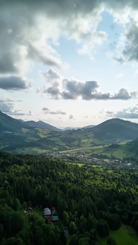 Vertical Aerial view of mountain landscape and village.