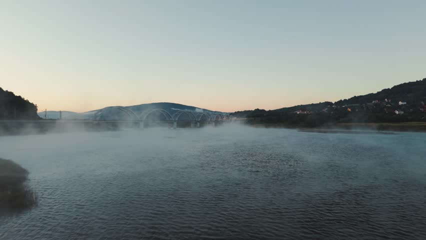 Drone Flight Over Misty Lake at Sunrise with Morning Fog