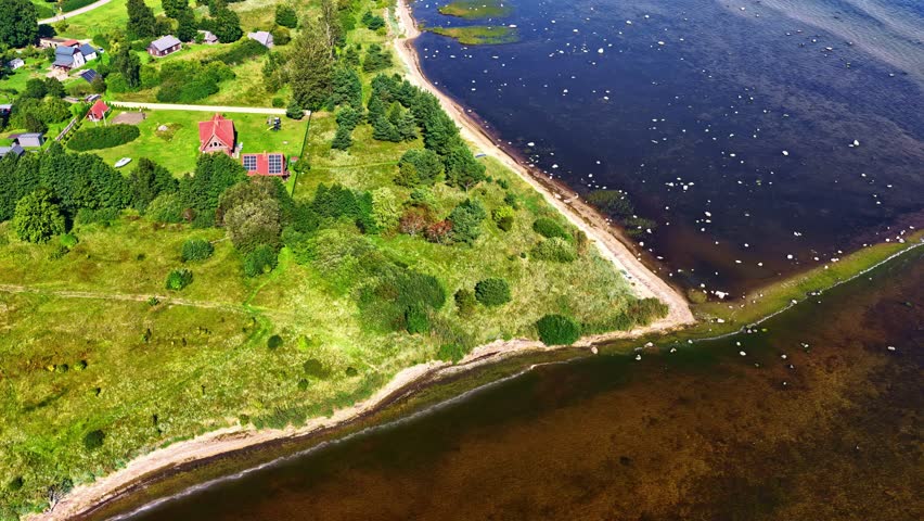 Overhead Shot of Rural Shoreline Village with Lush Greenery and Beach