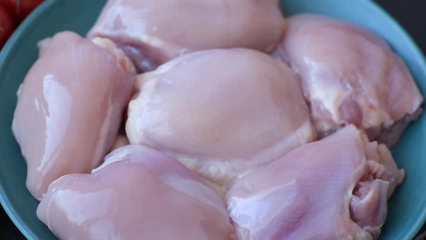 Raw chicken thigh fillet, poultry meat as a source of protein. Chicken thigh fillet as a food background for your design.