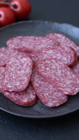 Sliced salami sausage, smoked meat as a delicacy for the table. Salami sausage as a food background for your design.