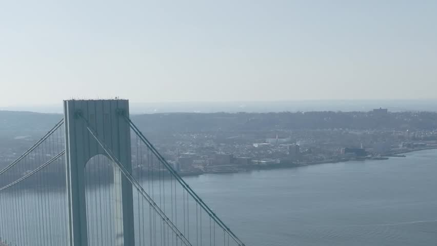 The photo shows the Verrazzano Narrows Bridge in New York, connecting Staten Island to Brooklyn.