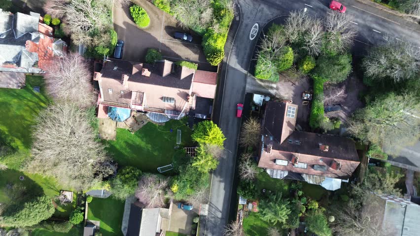 Cinematic straight‑line aerial pass over British suburban housing in Wirral, Merseyside. Captures rooftops, roads and community layout, suitable for documentaries, planning visuals and real‑estate marketing.