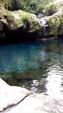 Stunning natural blue lagoon with crystal clear water and rocky surroundings.