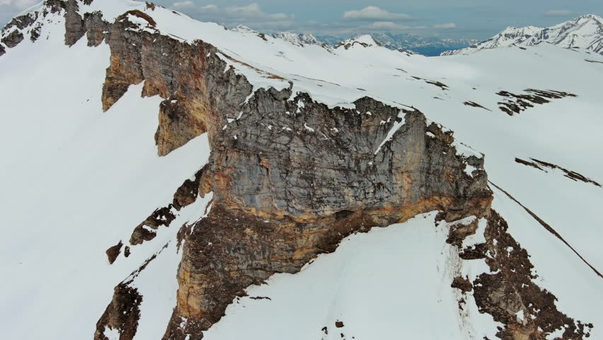Aerial around view of snow mountain range landscape with clouds. Alps mountains, Austria, 4k