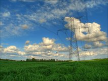 Fluffy clouds over electrical pylons, HD time lapse clip, high dynamic range imaging