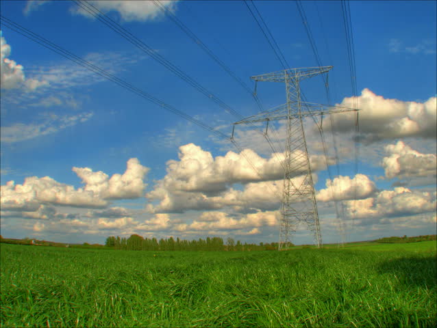 Fluffy clouds over electrical pylons, HD time lapse clip, high dynamic range