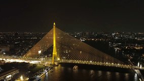 Aerial view of illuminated Rama VIII Bridge at night. Cable-stayed bridge crossing Chao Phraya River in Bangkok, Thailand, 4k - Powered by Shutterstock - Get 15% off with code: PIKWIZARD15