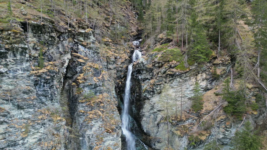 Aerial view of Jungfernsprung Waterfall in forest mountain. Austrian Alps, Austria, 4k
