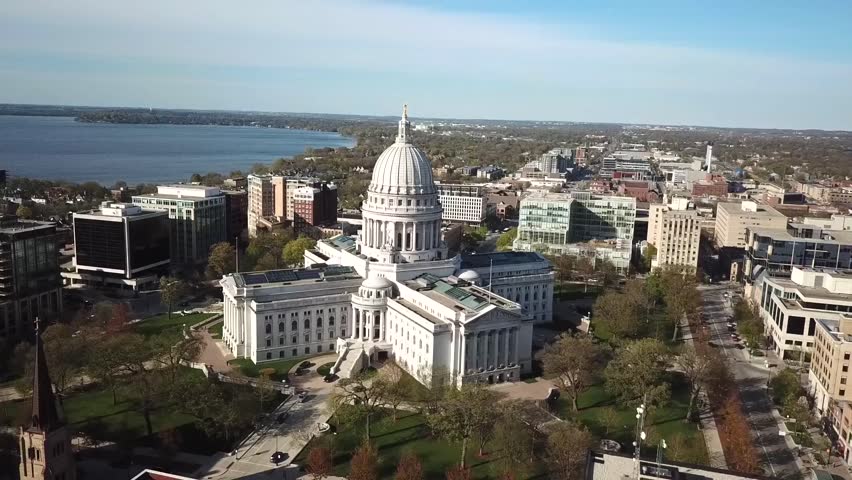 Aerial view of government capitol building with surrounding city.