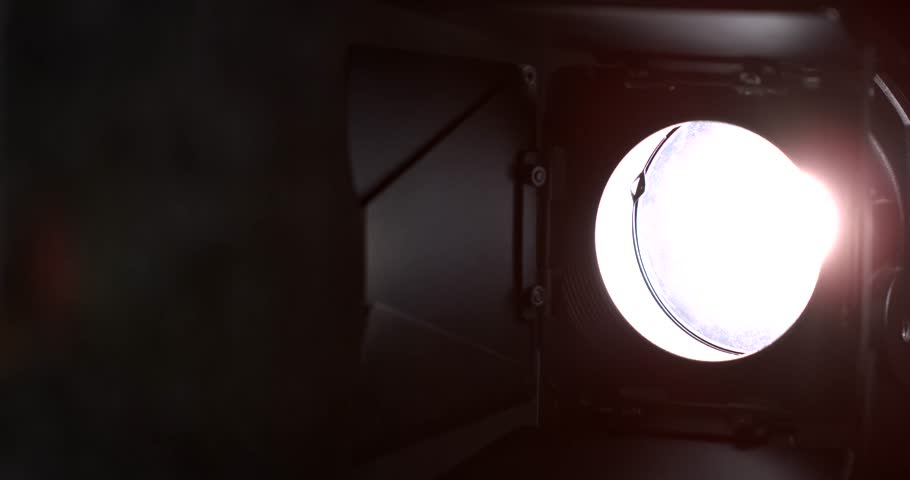Slow motion, Studio Stage Spotlight Centered On Aperture, Warm Dramatic Glow With Rehearsal Cues And Dimmer