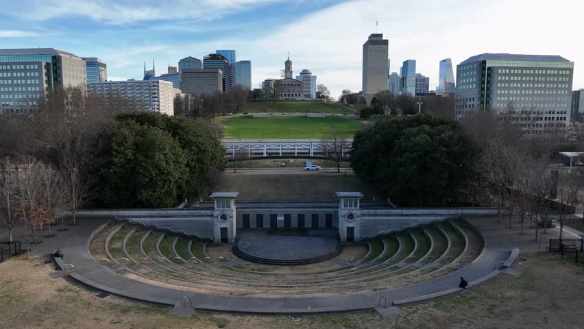 Aerial view of Tennessee State Capitol in Nashville, with city skyline, surrounding parkland and urban architecture. clear sunny daylight from above. Wide shot. Establishing shot.