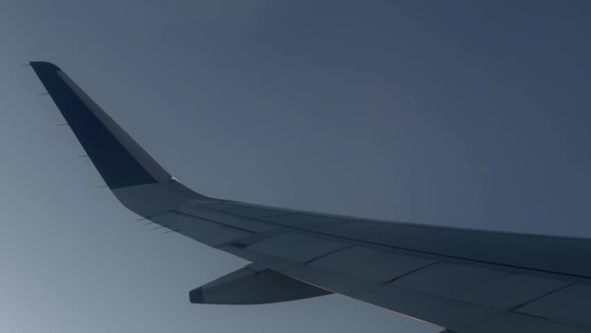 Flight wing View from inside airplane flying above over sky