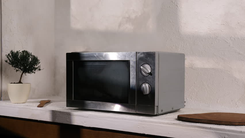 Microwave oven is smoking in kitchen while cooking.