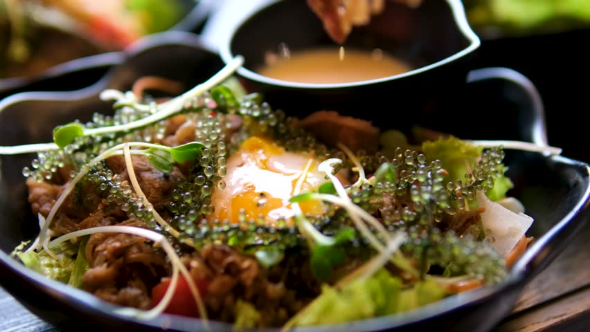 dipping meat in egg yolk, eggs Benedict in salad, poached egg, Asian food