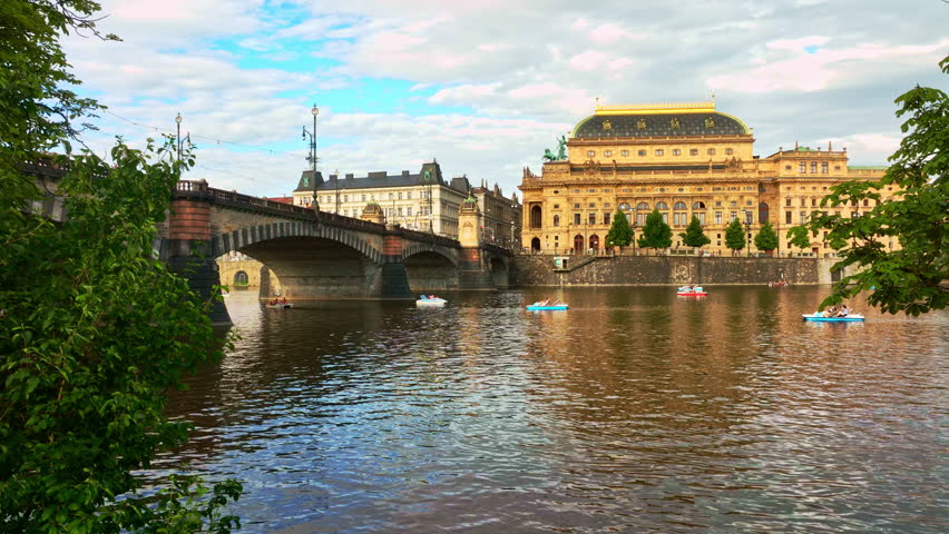 Theatre in Prague city. Opera heritage across water. Theatre historic Prague city center. Theatre stands iconic in Prague near Vltava River. Praha city theatre. Prague opera aerial view.