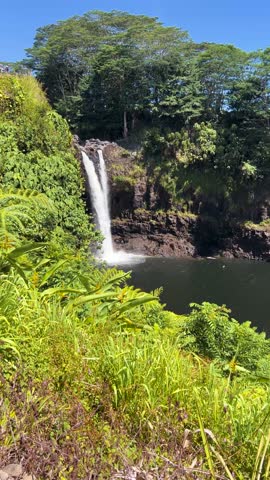 Tranquil waterfall in lush Wailuku River State Park on Big Island, Hawaii