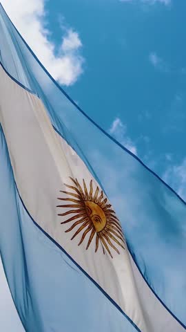 Vertical Closeup Of Argentina National Flag Waving In Blue Summer Daylight