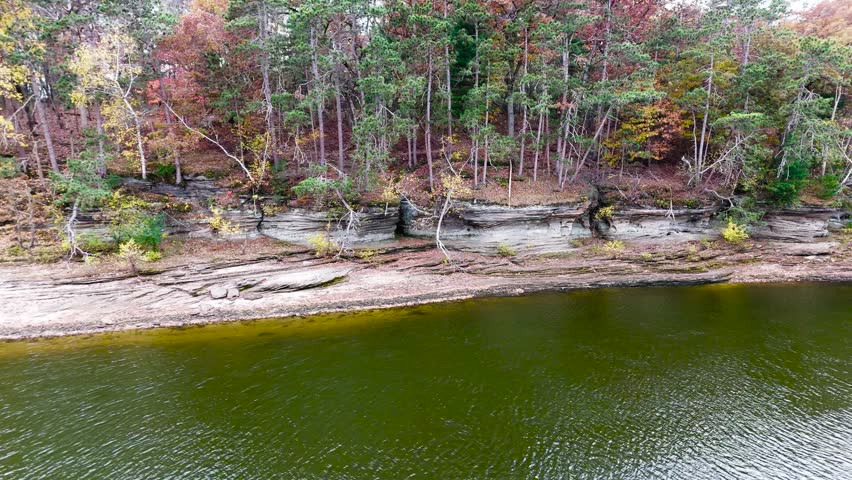 Aerial Pan Of Vibrant Fall Colors Along Wisconsin River Shoreline