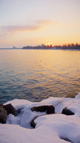 Snow-covered shoreline and shimmering water in winter
