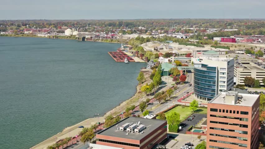 Aerial view of Evansville, Indiana along the Ohio River on a sunny day, showcasing riverfront skyline, bridges, and vibrant Midwestern cityscape.