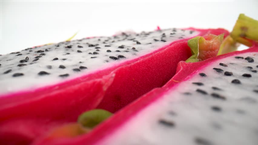 Macro of cut dragon fruit pitaya on white background isolated