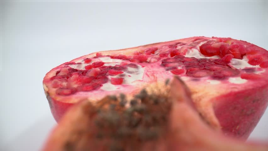 Macro of cut pomegranate on white background isolated