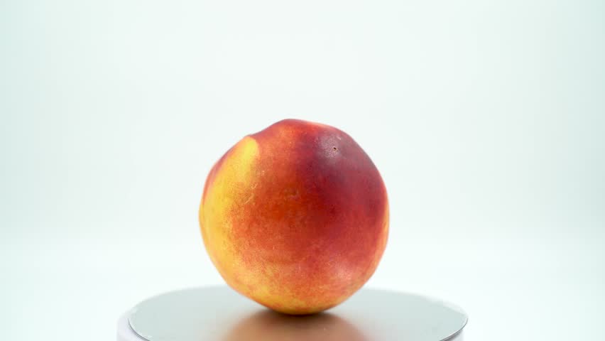 Close up of peach nectarine on white background isolated