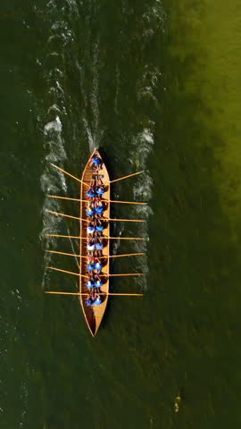 Vertical drone shot above a viking church boat rowing in the finnish archipelago